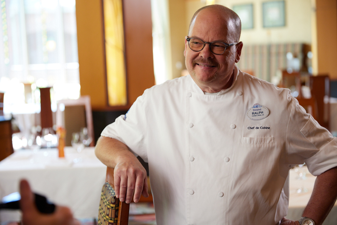 Chef Ralph standing in a dining room.