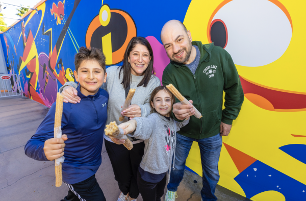 Make a Wish kid Ross holds churros with his family