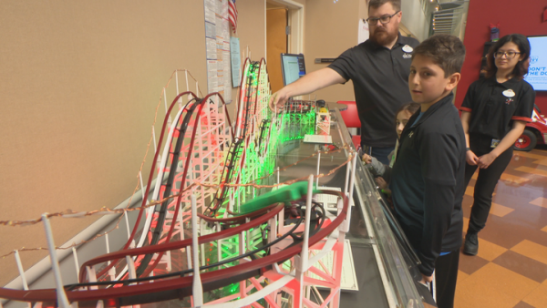 disney Imagineer with roller coaster model